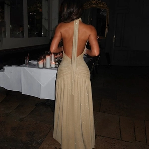 Elegant gold backless halter maxi dress with shimmering fabric for evening gala events