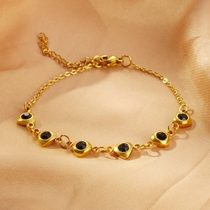 Fashionable gold stainless steel bracelet featuring six black heart-shaped zircon stones