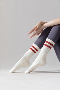 Détail de chaussettes de yoga en coton blanc avec rayures rouges et texture côtelée