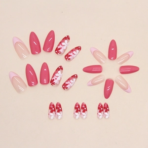 Pink almond press-on nails with floral patterns and French tips in a glossy finish