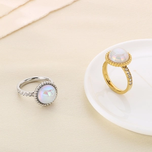 Detailed macro view of gold and silver rings with large opals and diamond accents