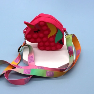 Pink unicorn silicone sensory pop fidget shoulder bag with rainbow strap on white stand