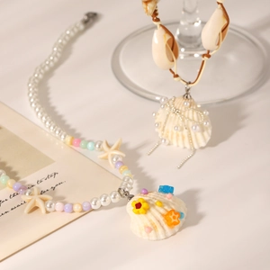 Detail of beach-style necklaces featuring starfish charms, natural shells, and pearls