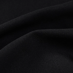 Detailed macro view of the premium black high-density knitted fabric texture and draping