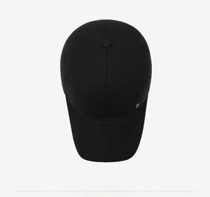 Top-down macro view showing black cross-textured fabric and crown button of baseball cap