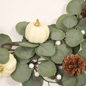 White Christmas pumpkin wreath with eucalyptus leaves, pine cones, and berries for door hanging