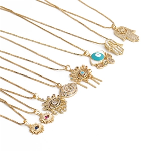 Golden Evil Eye and Hamsa Hand pendant necklace set with cubic zirconia stones