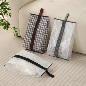 Three houndstooth and mesh shoe storage bags with handles for travel and boot protection