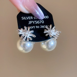 Detail view of Silver 925 firework stud earring with zirconia and white pearl drop