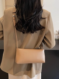 Elegant camel faux leather baguette bag for women shown with professional styling