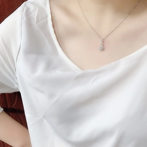 Close-up of 2-carat round zircon pendant necklace worn on neck with PT950 plating