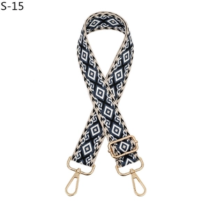 Close-up of adjustable geometric diamond pattern bag strap with gold metal hardware