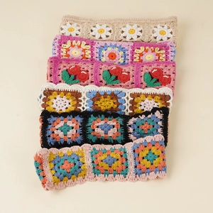 Detailed close-up of handmade crochet headbands with floral and bohemian knit patterns