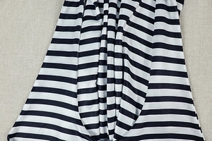 Close-up of black and white striped fabric showing texture and gathered waist detail