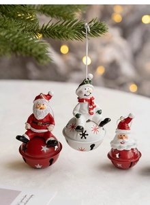 Close-up of Santa Claus and Snowman figurines with hollow metal star-pattern bells