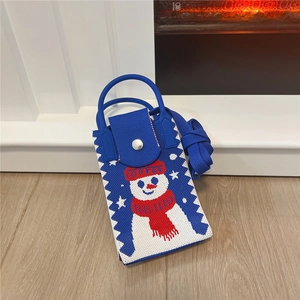 Detail showing the blue knitted mini phone bag with a cute snowman pattern and long strap