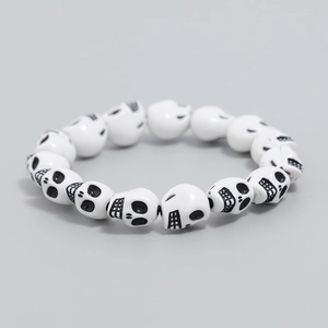Macro view of white skull beads with black details on a gothic retro stretch bracelet