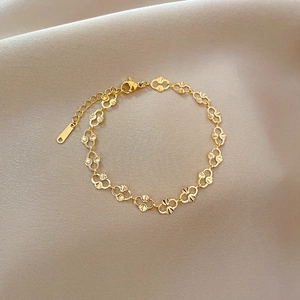 Gold stainless steel bracelet featuring hollow fan-shaped links and adjustable clasp