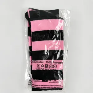 Pink and black striped thigh-high socks in clear protective plastic packaging