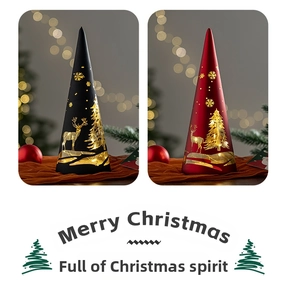 Close-up of cone-shaped Christmas glass lanterns with reindeer and snowflake patterns