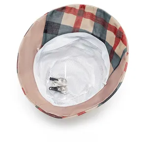 Detail of breathable mesh lining and adjustable windproof cord on plaid sun hat