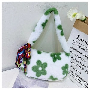 Detailed plush handbag texture featuring white and green floral print with silk scarf
