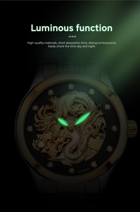 Lueur verte lumineuse sur le cadran dragon doré et les aiguilles de montre automatique