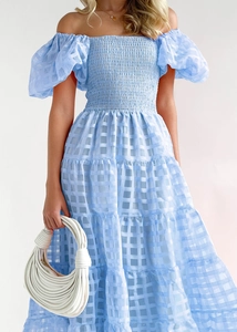 Detail of light blue checkered off-shoulder puff sleeve dress with tiered skirt