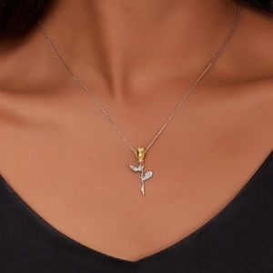 Elegant S925 silver necklace featuring a two-tone golden rose pendant on a model