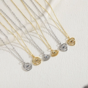 Detailed display of evil eye necklaces in gold and silver finish with blue zircons