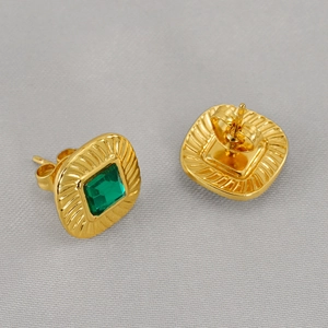 Detailed view of square green zircon earrings with retro gold radial texture