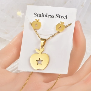 Close-up of golden stainless steel apple jewelry set including necklace and earrings