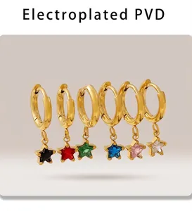 Detail view of colorful star charms on gold hoop earrings with PVD plating finish