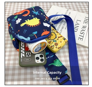 Detail showing inner capacity of navy blue kids dinosaur chest bag with smooth zippers