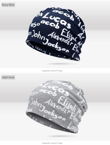 Detail of navy and grey knitted beanies featuring white cursive artistic name prints