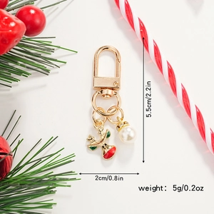 Detailed view of Christmas reindeer keychain with gold plating and pearl on festive background