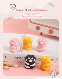 Close-up of cat paw pencil sharpeners in pink and yellow colors on a desktop set