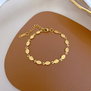 Minimalist gold oval link chain bracelet in stainless steel with sunburst texture