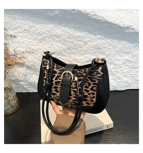 Detail of leopard print stitching with black leather and gold horsebit hardware on bag