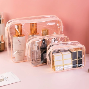Three-piece set of transparent waterproof PVC toiletry bags with pink trim and zippers