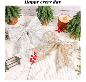 Close-up of glittery gold and silver Christmas bows on a festive knitted background