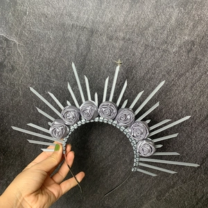 Close-up of silver Gothic halo headband with satin roses and metallic stars
