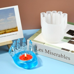 Blue translucent hand-shaped candle holder made from resin DIY silicone mold with lit tealight