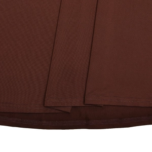 Detail of dark brown knitted dress showing high-quality stitching and fabric texture