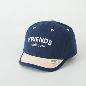 Detail of navy cotton kids baseball cap featuring white Friends embroidery and beige brim