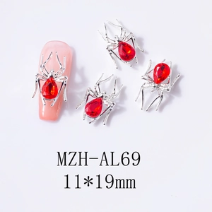 Macro view of silver spider nail charm with red teardrop gem and 11x19mm size