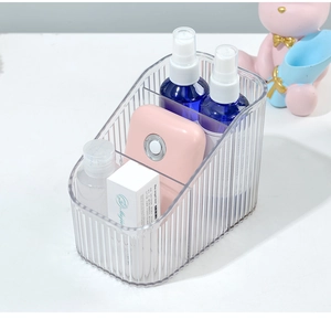 Close-up of clear acrylic eyelash storage box with two compartments and vertical texture