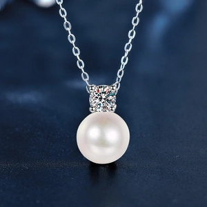 Macro detail of S925 sterling silver pearl necklace with sparkling moissanite pendant