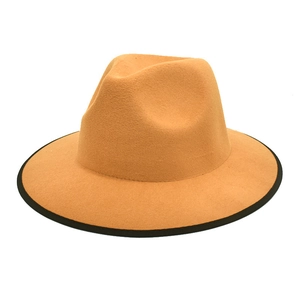 Detail of camel wool fedora hat featuring wide brim and black contrast piping edge