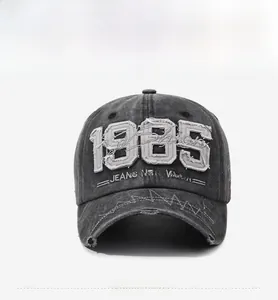 Detailed front view of washed black vintage baseball cap with 1985 embroidery